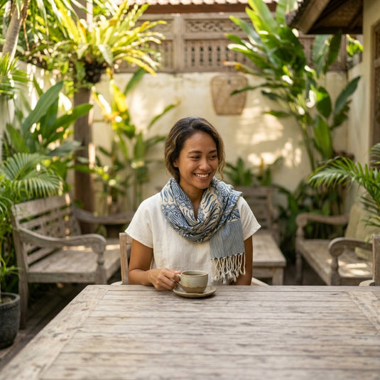 Washed blue batik everyday scarf worn in a relaxed tropical Bali setting
