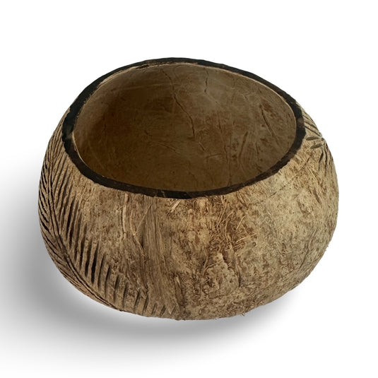 Hand-carved coconut shell bowl interior with palm leaf pattern
