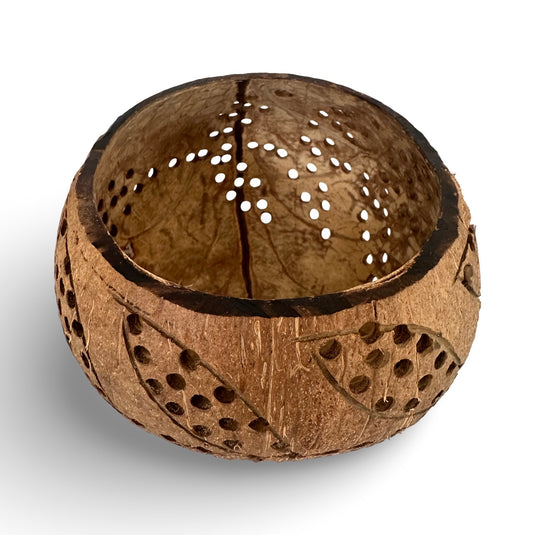 Hand-carved coconut shell lantern with decorative cutout pattern