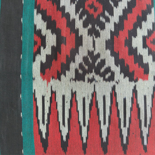 Close-up of the Mount Agung handwoven ikat blanket showcasing the traditional woven pattern