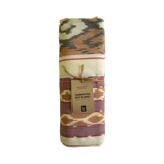Folded handwoven ikat blanket with Hello Ketut product tag