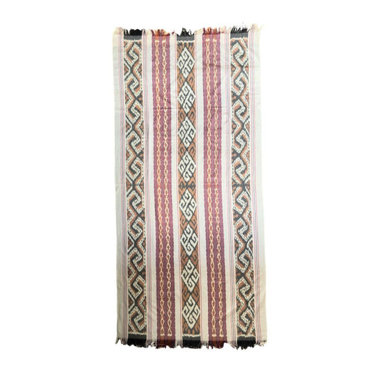 Handwoven ikat blanket in the Sunwashed Sand pattern with traditional woven stripes