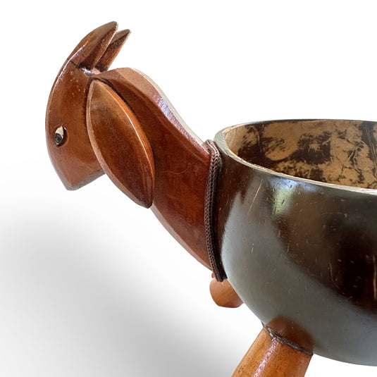 Close-up of hand-carved goat head on coconut shell keeper bowl