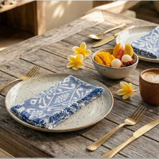 Handwoven Endek table napkin set in soft indigo styled on dining table setting