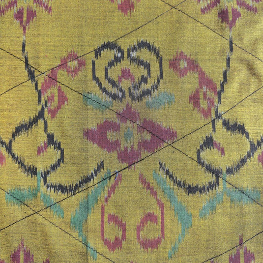 Handwoven endek tea towel in golden saffron ikat pattern detail