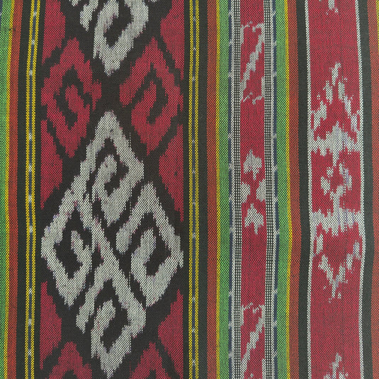 Close-up of the Island Ritual handwoven ikat blanket showcasing the traditional woven pattern