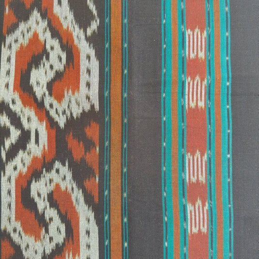 Close-up of the Teak Forest handwoven ikat blanket showcasing the traditional woven pattern