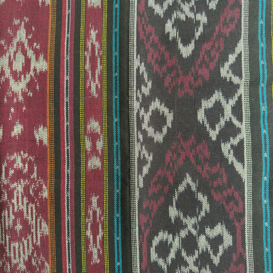 Close-up of the Temple Night handwoven ikat blanket showcasing the traditional woven pattern