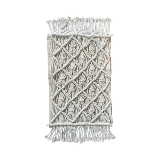 Folded macramé cushion cover showing the full hand-knotted pattern and fringe edges