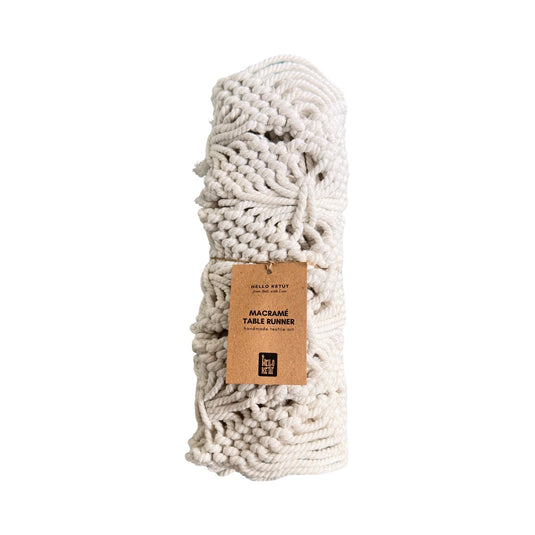 Handmade macramé table runner rolled with kraft paper label