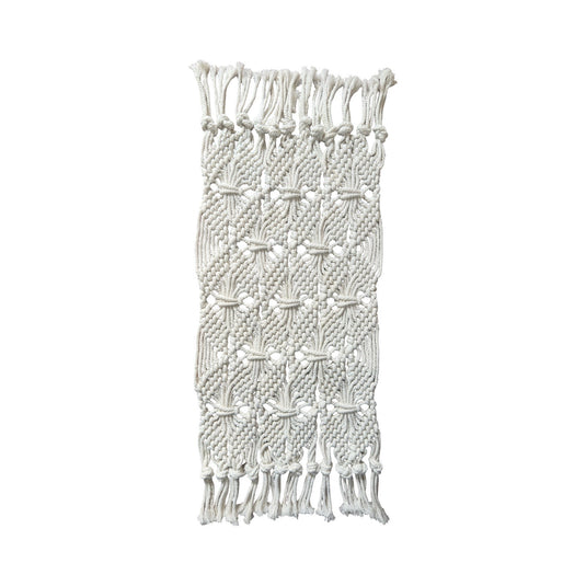 Handmade macramé table runner with knotted pattern