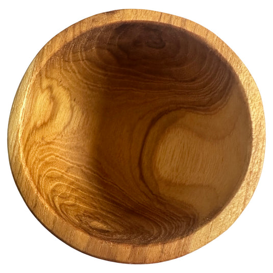 Close-up top view of natural teak wood grain inside mortar bowl